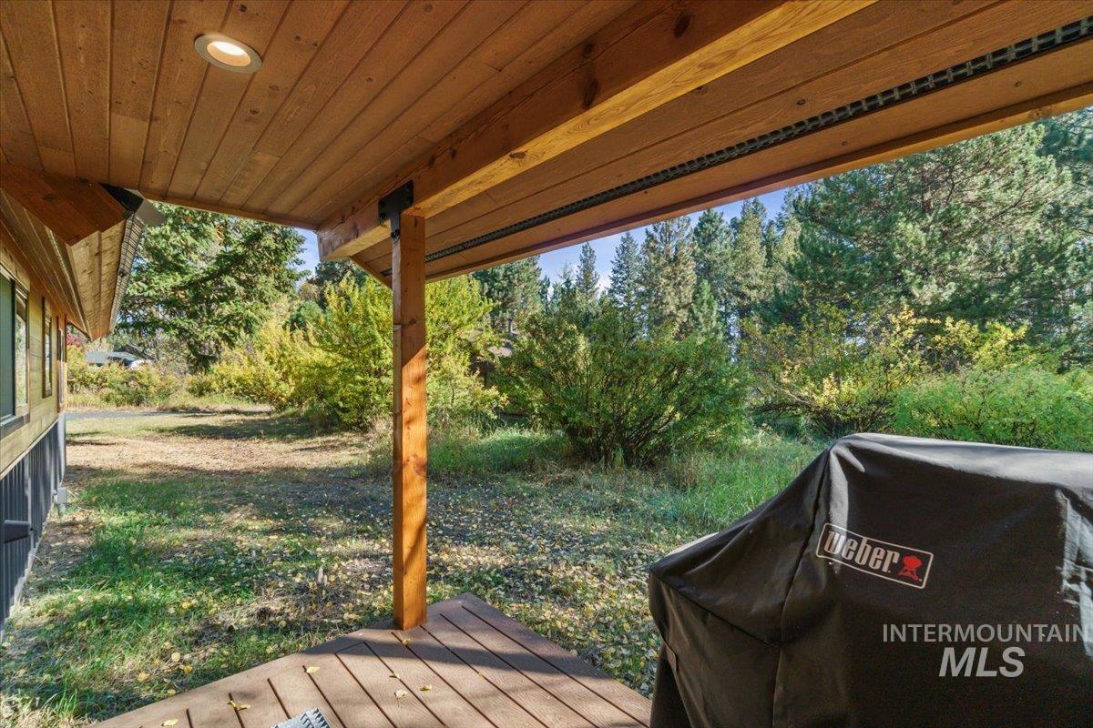 Wooden terrace featuring area for grilling