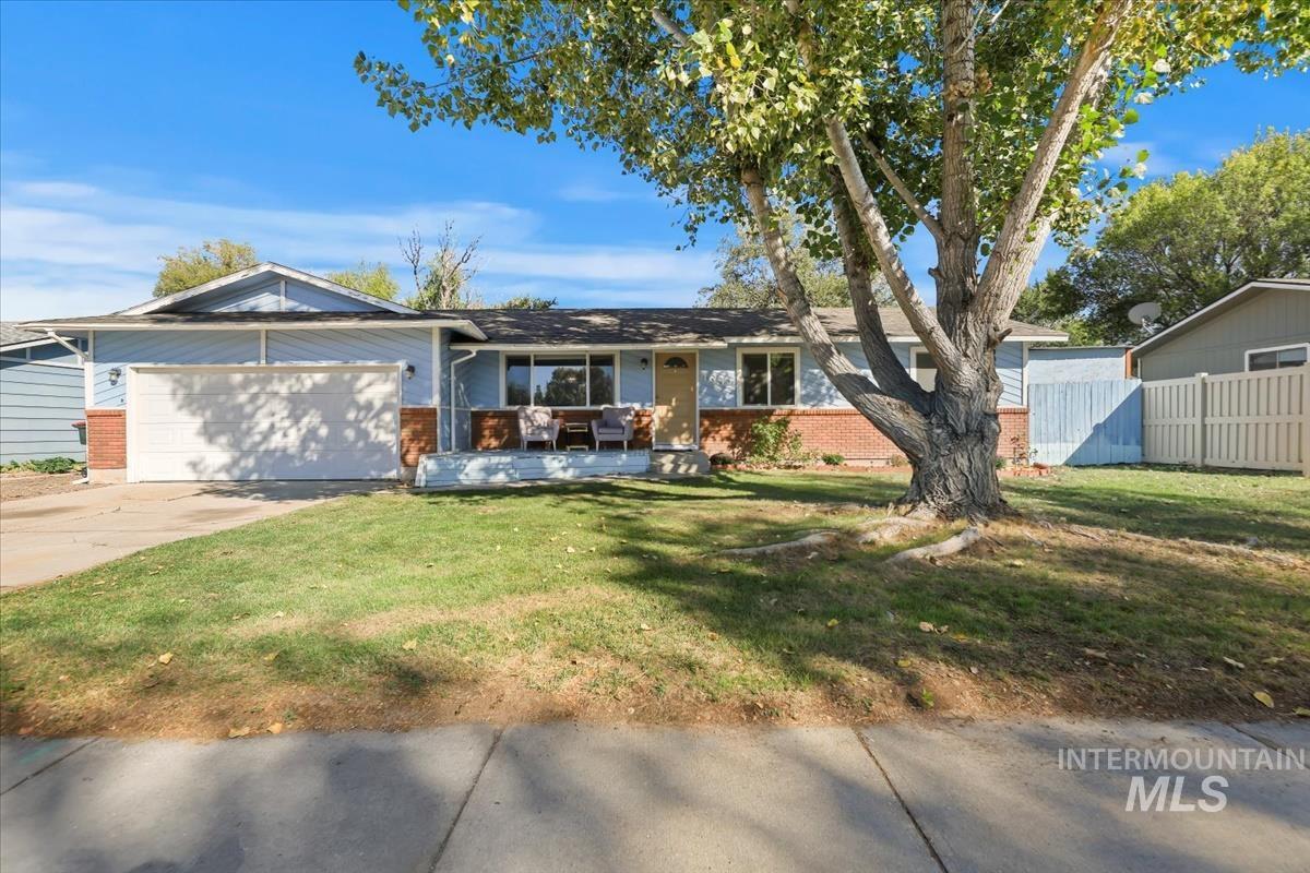 Single story home with brick siding, concrete driveway, and a garage