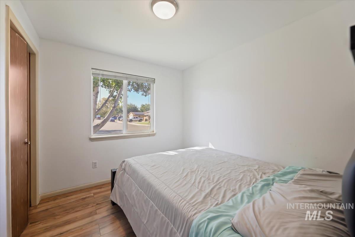 Bedroom featuring wood finished floors and a closet