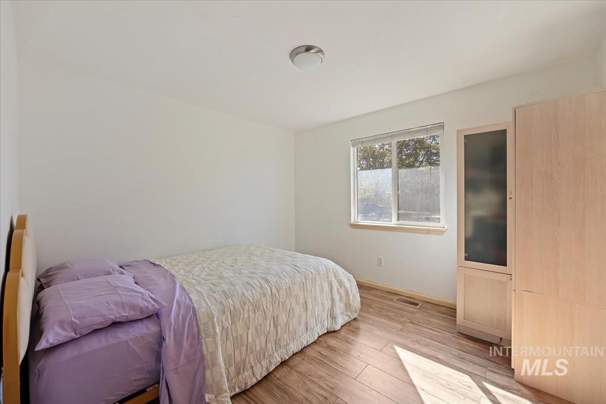Bedroom featuring wood finished floors and baseboards