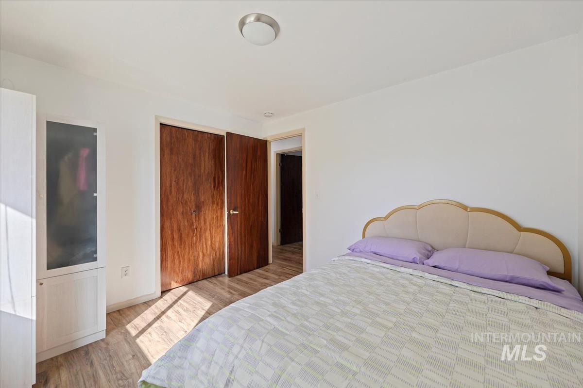 Bedroom featuring light wood-style flooring and a closet
