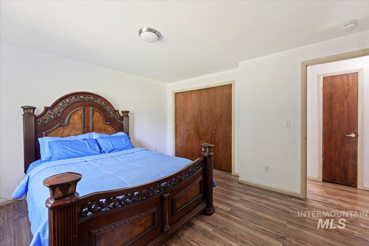 Bedroom featuring wood finished floors and a closet