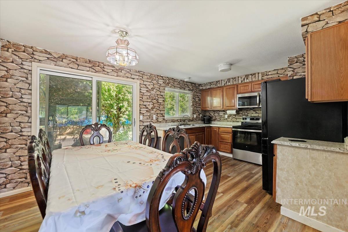 Dining area with light wood finished floors and a chandelier