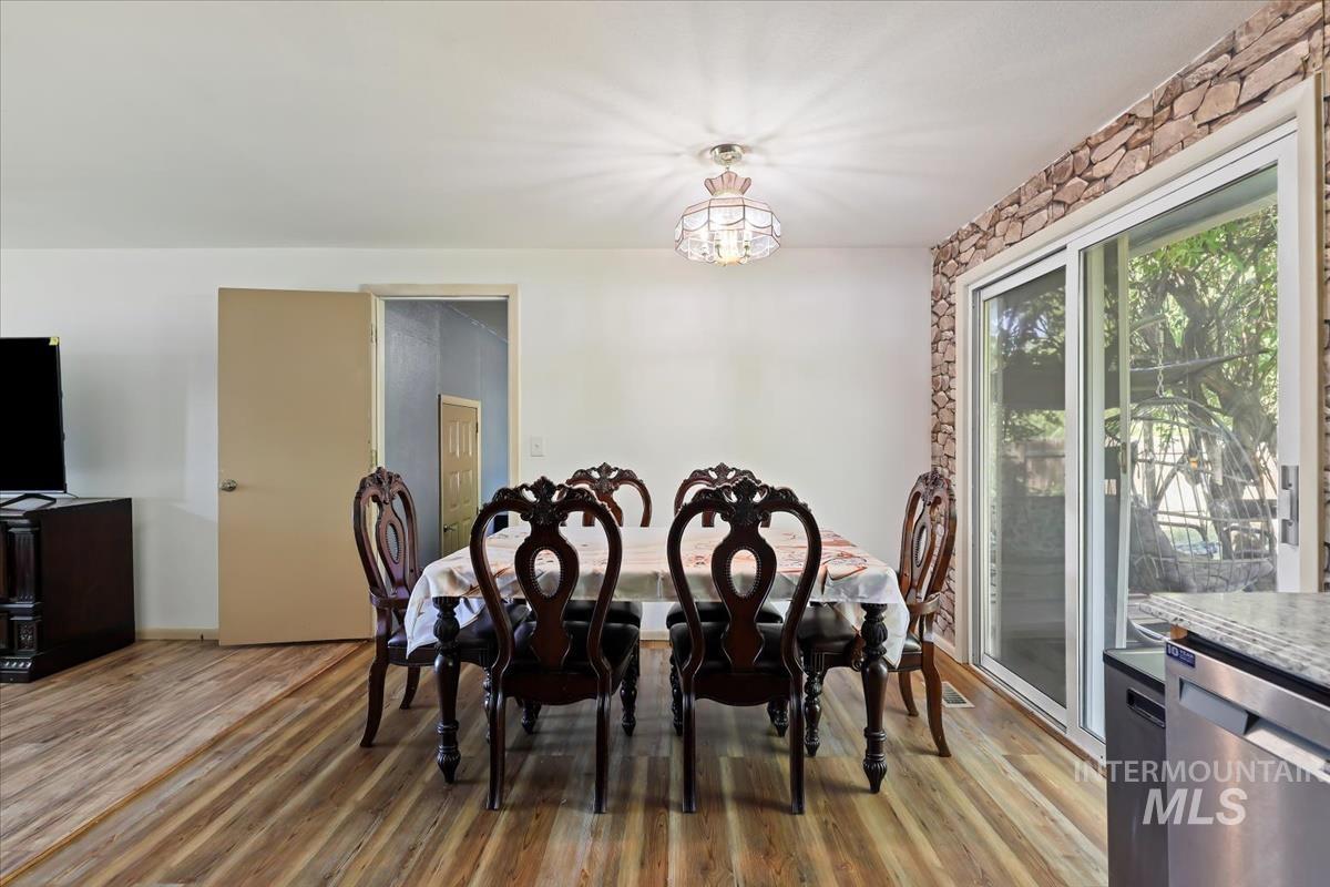 Dining space with light wood finished floors and a chandelier
