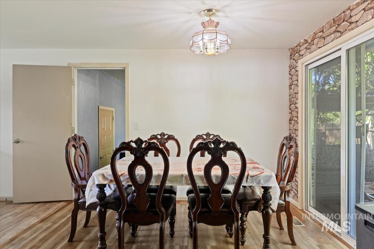 Dining room with light wood-style flooring and a chandelier