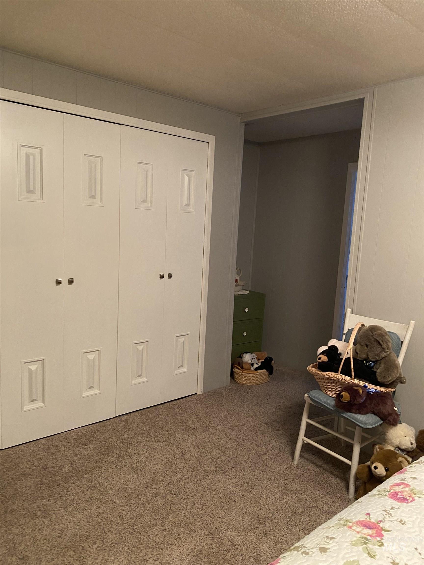 Carpeted bedroom with a closet and a textured ceiling