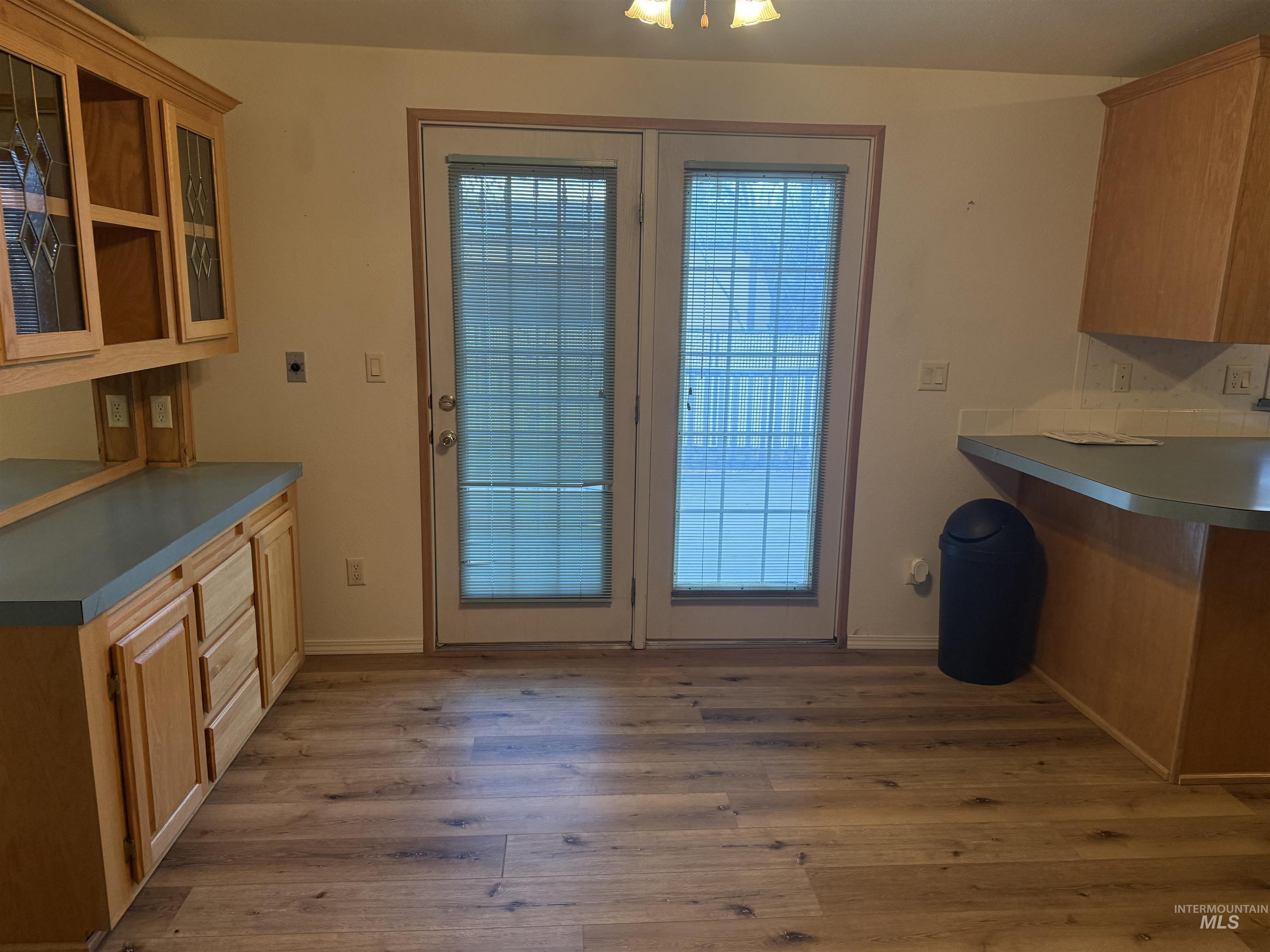 Unfurnished dining area with light wood-type flooring and baseboards