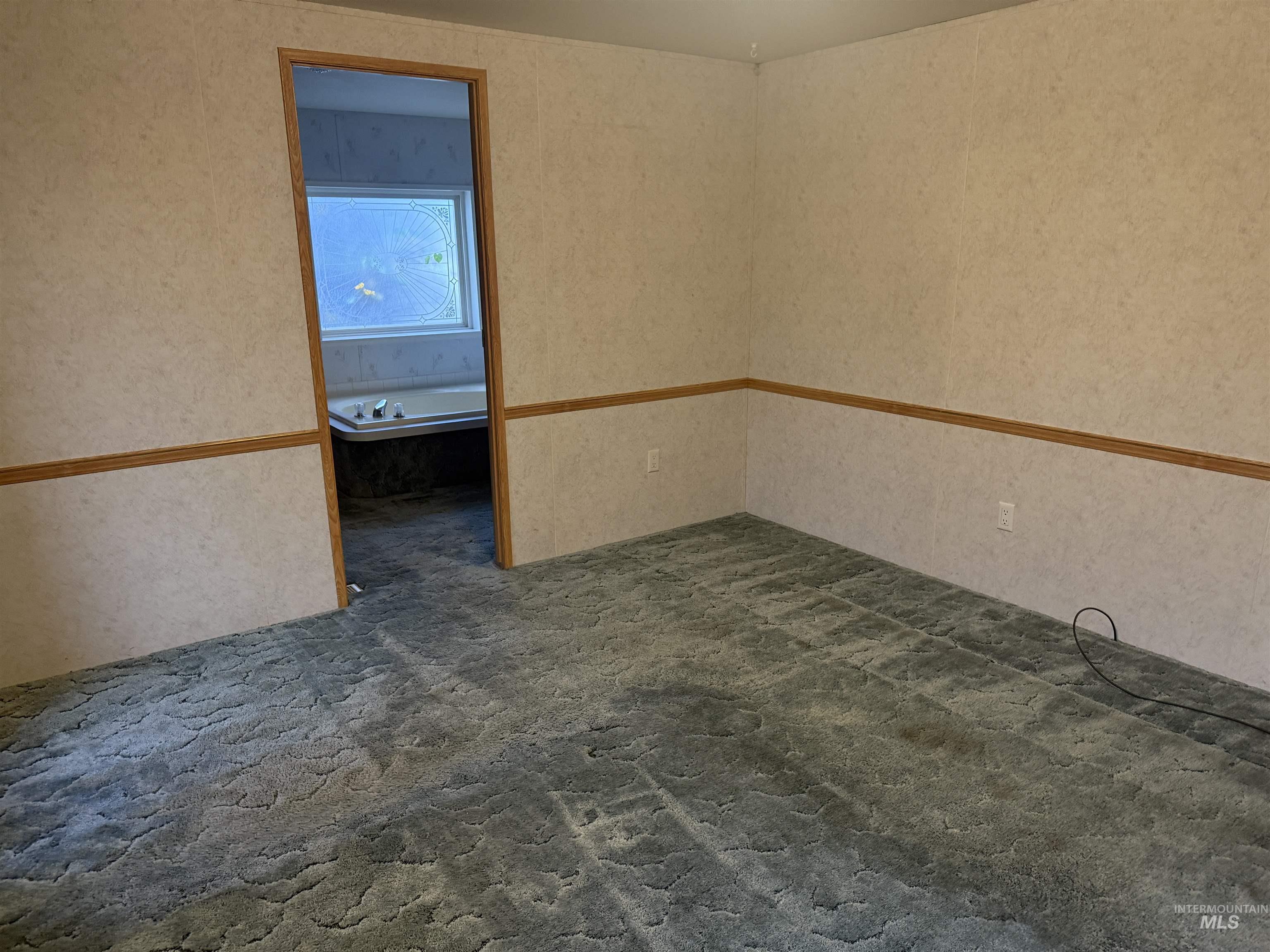 Spare room with dark stone finish floors