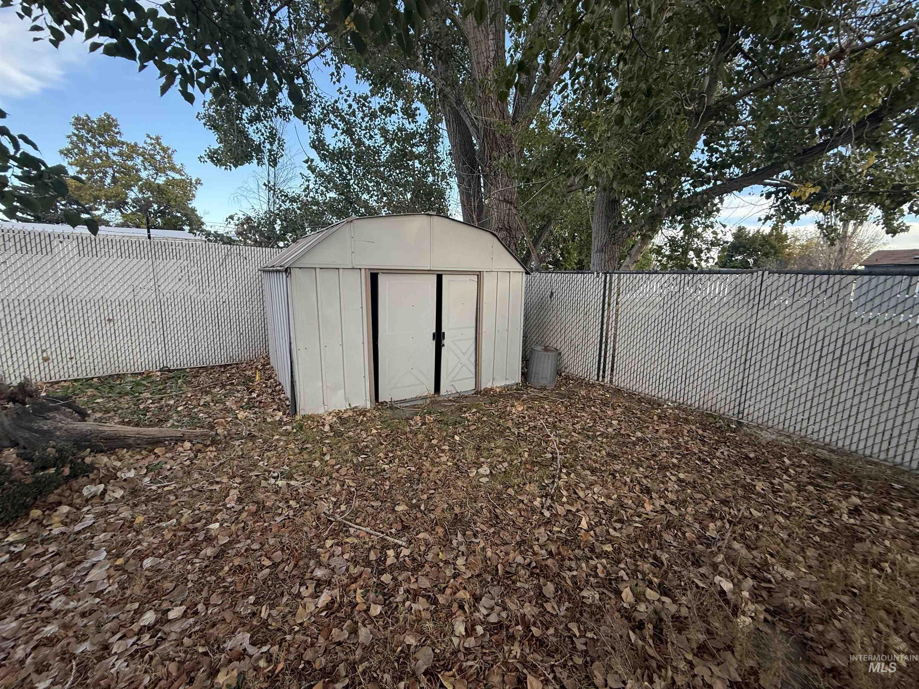 View of shed with a fenced backyard