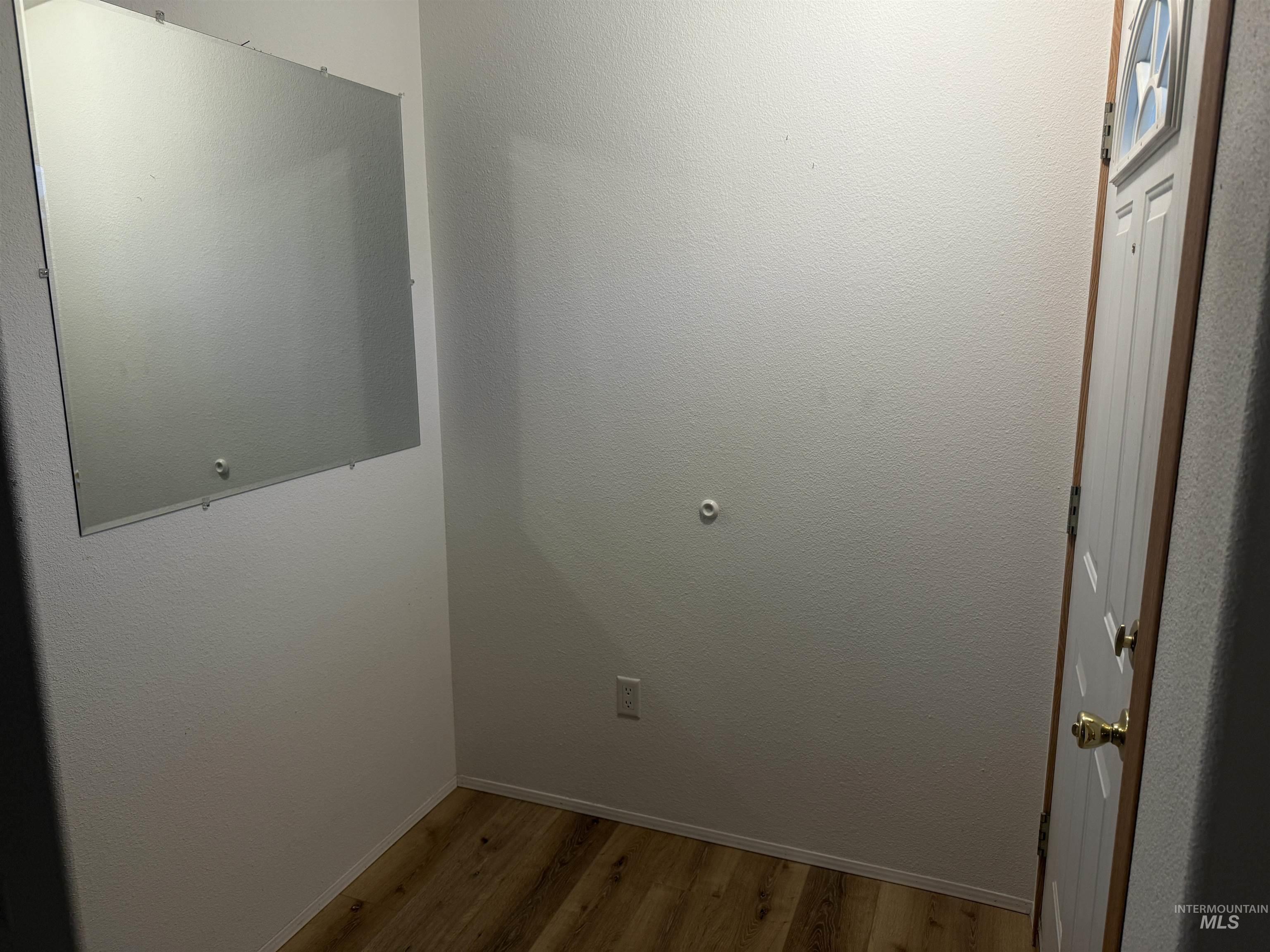 Washroom featuring light wood finished floors and baseboards