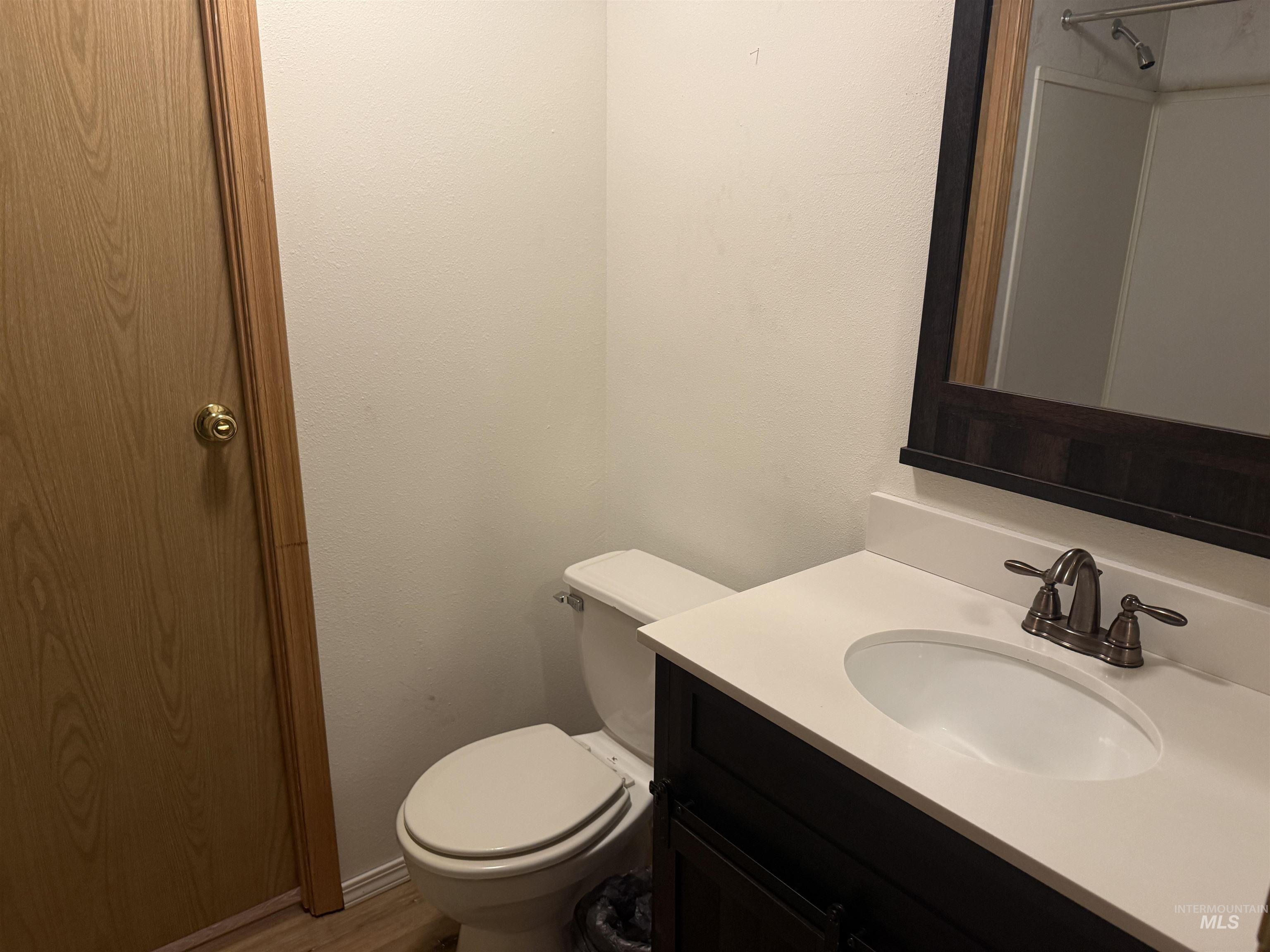 Half bath featuring vanity and light wood-style flooring