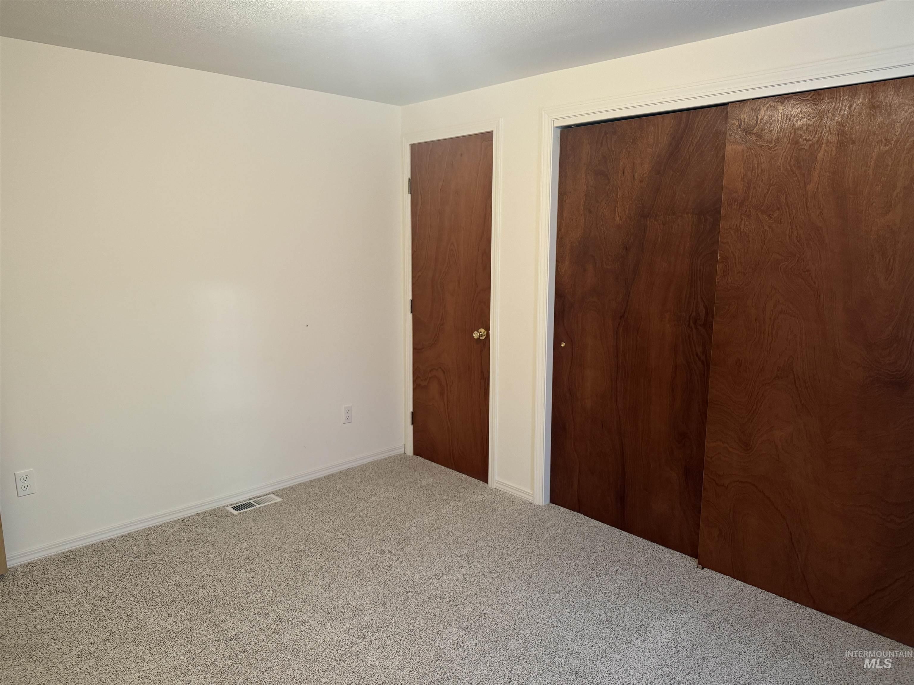 Unfurnished bedroom featuring a closet and carpet