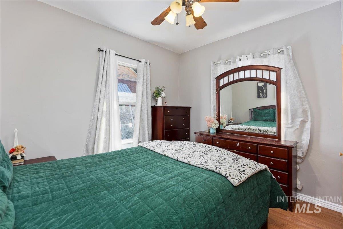 Bedroom with wood finished floors and a ceiling fan