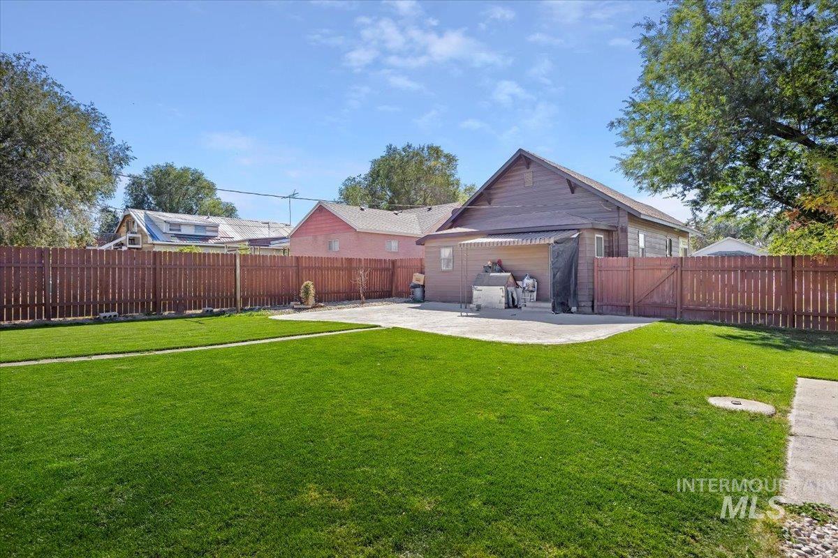 Fenced backyard with a patio area
