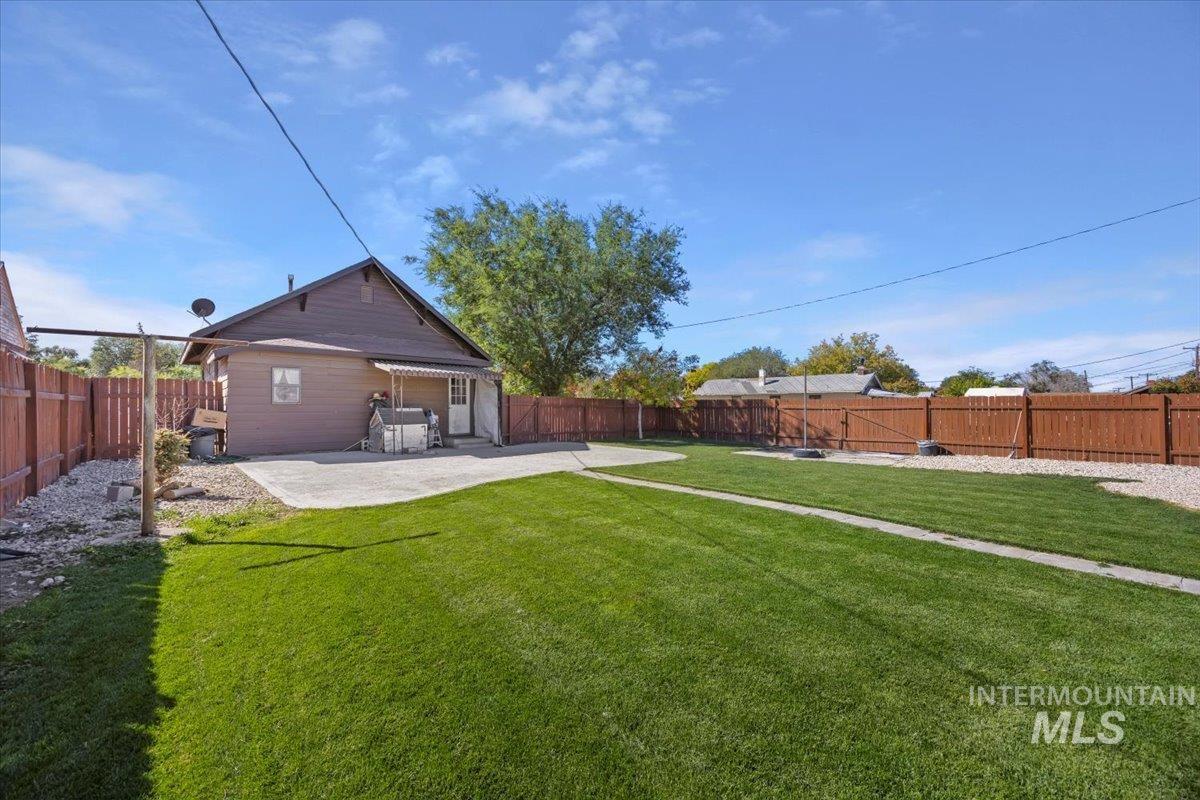 Fenced backyard with a patio area