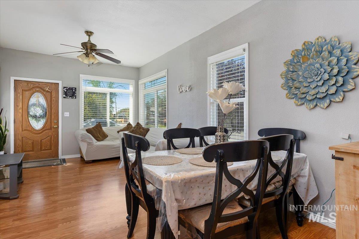Dining area with light wood-style flooring and a ceiling fan