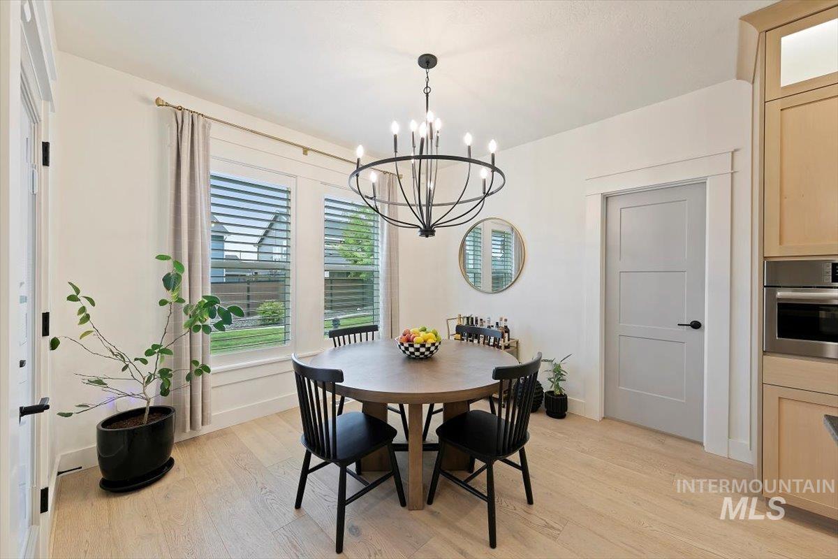 Dining area featuring light wood finished floors and a chandelier