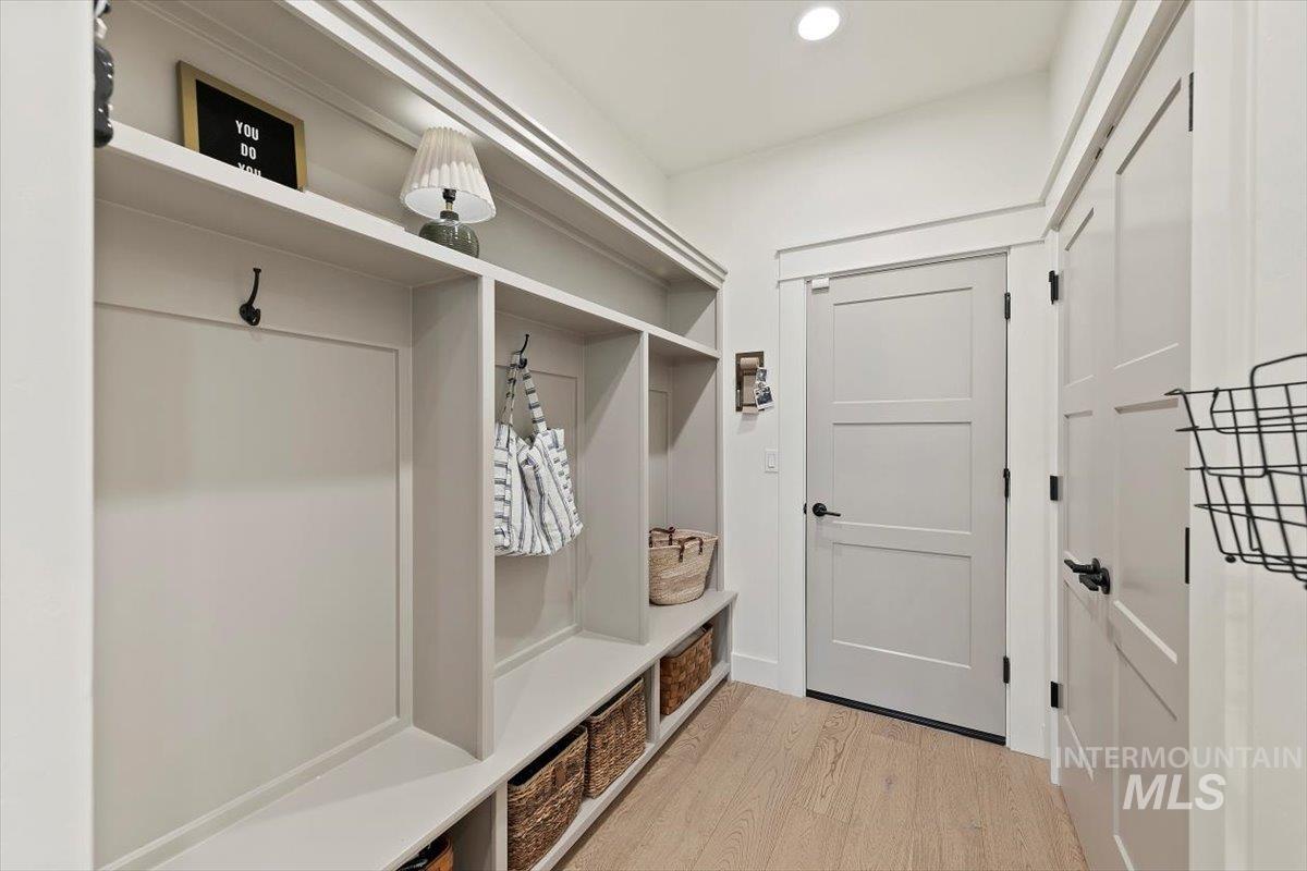 Mudroom with light wood finished floors and recessed lighting