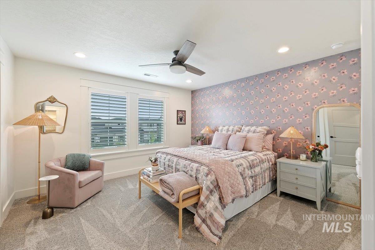Carpeted bedroom featuring recessed lighting, a ceiling fan, and wallpapered walls