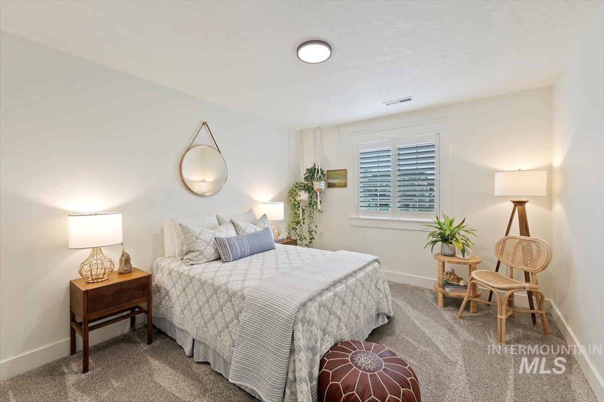 Bedroom featuring carpet floors and a textured ceiling