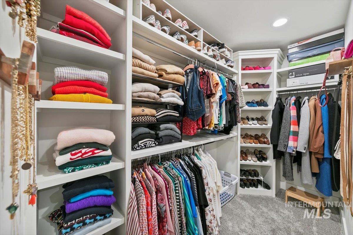 Spacious closet with light colored carpet