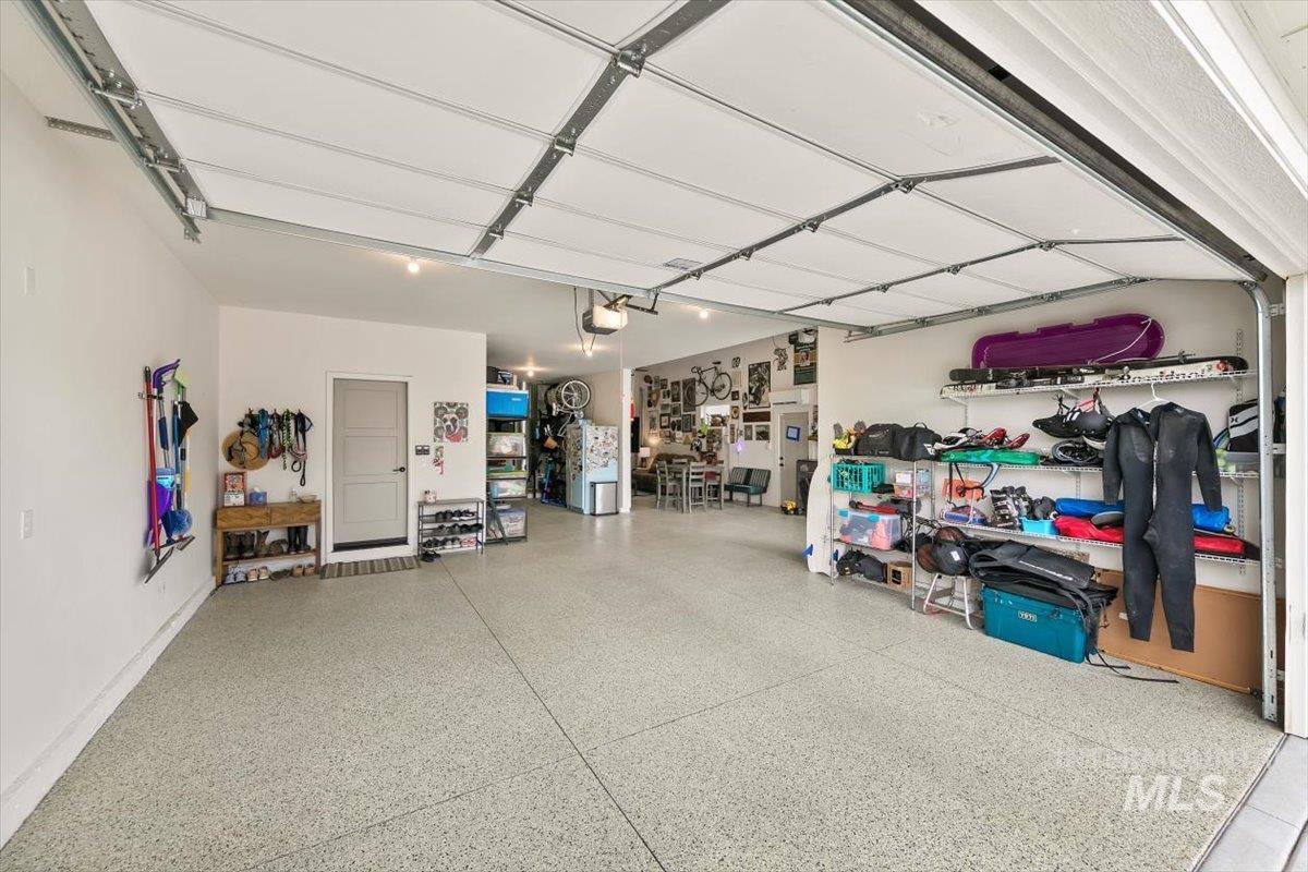 Garage featuring freestanding refrigerator