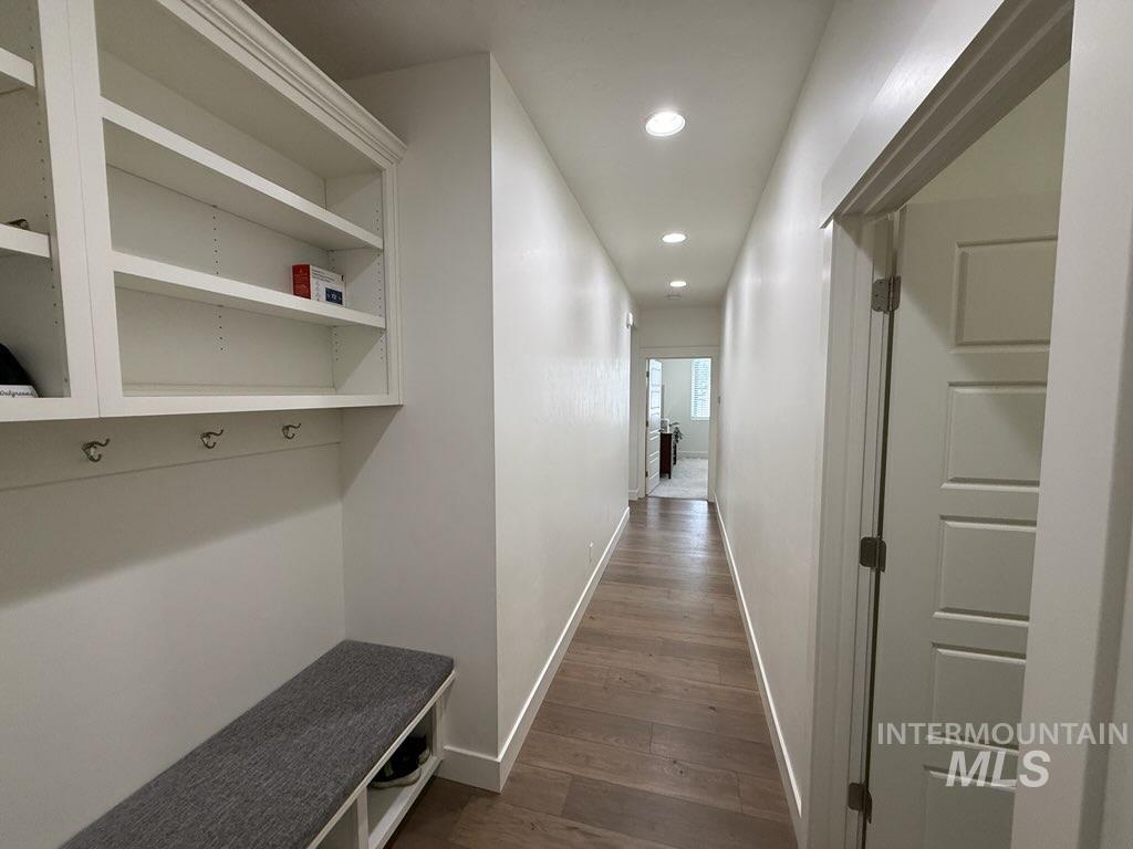 Mudroom with dark wood finished floors and recessed lighting