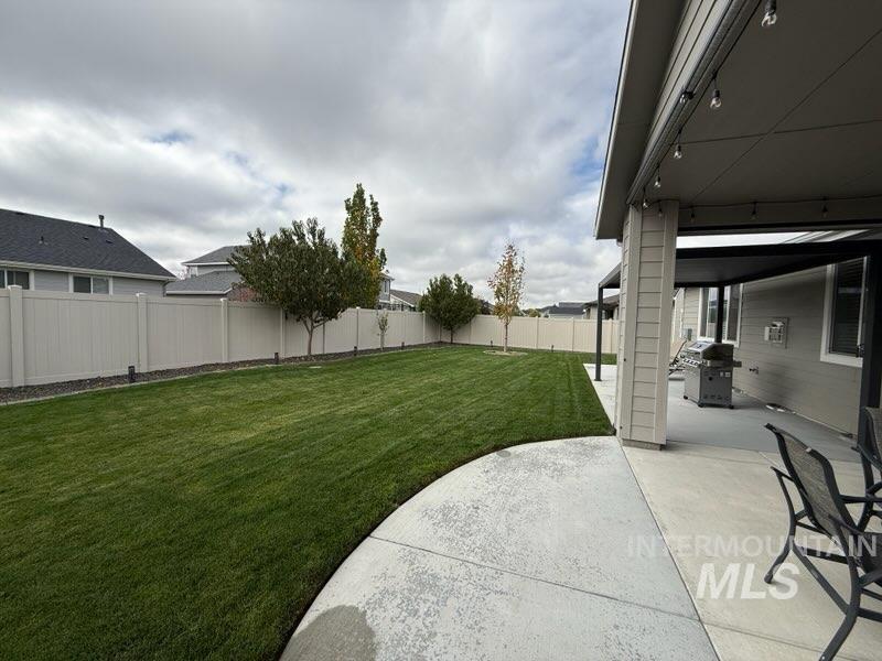 Fenced backyard with a patio area