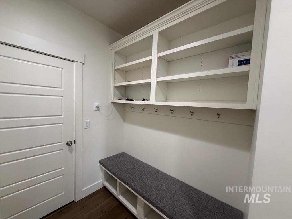 Mudroom with dark wood-style flooring and baseboards