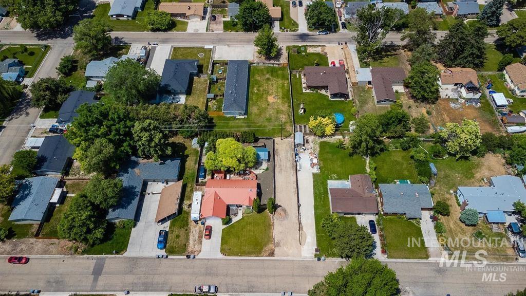 Aerial view of property and surrounding area with nearby suburban area