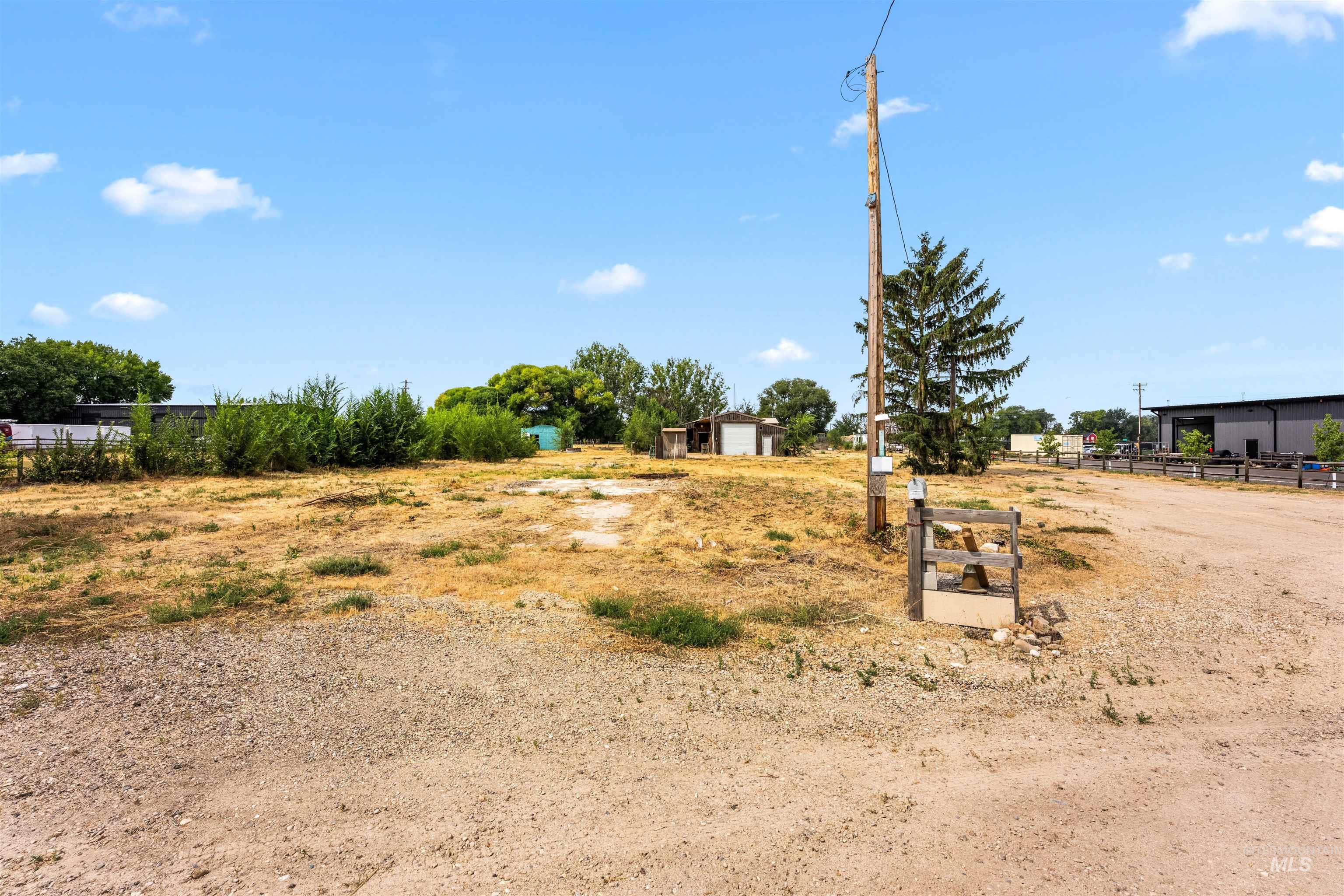 View of yard featuring a rural view and an outbuilding