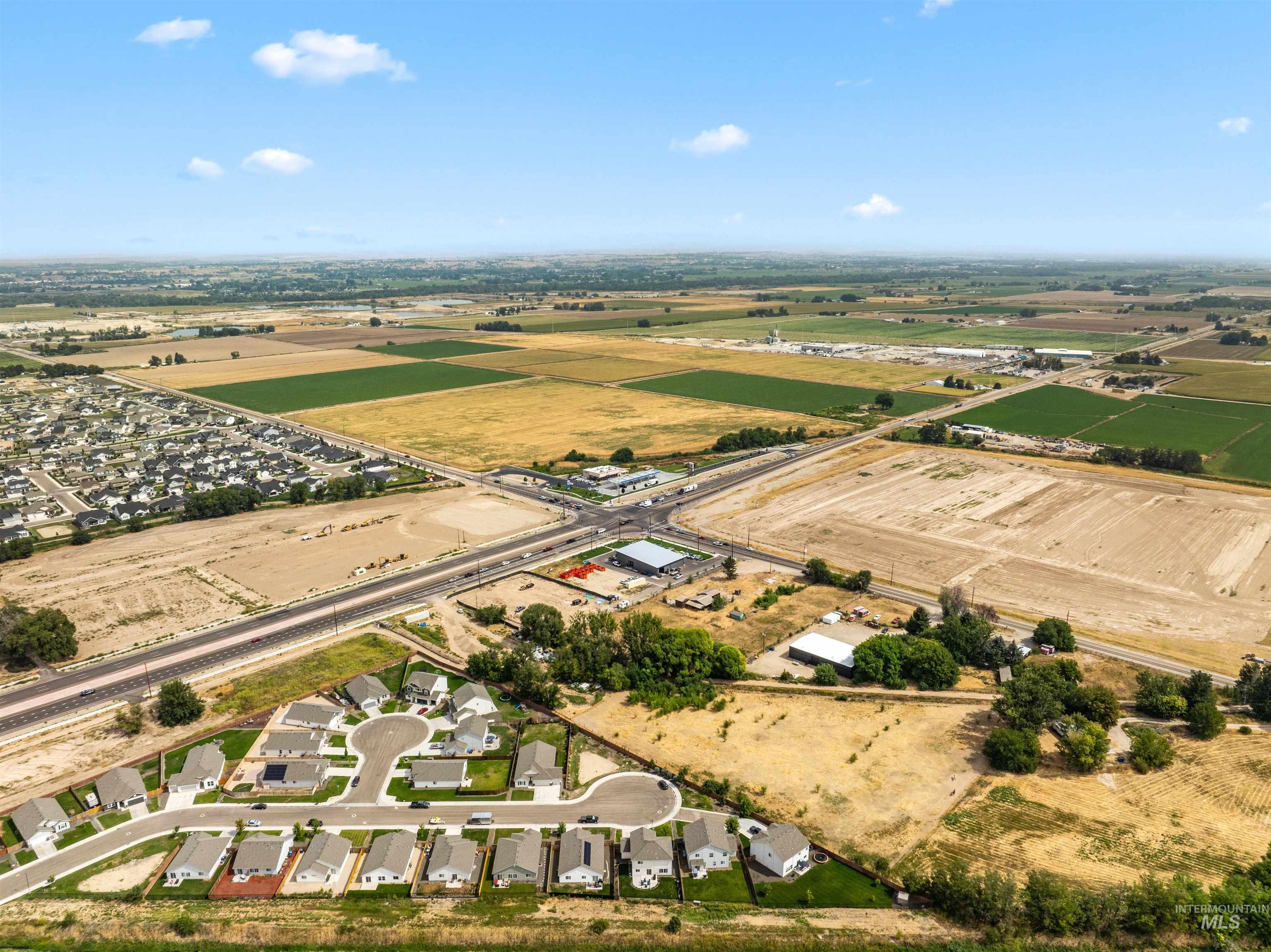 Aerial overview of property's location with nearby suburban area and rural landscape