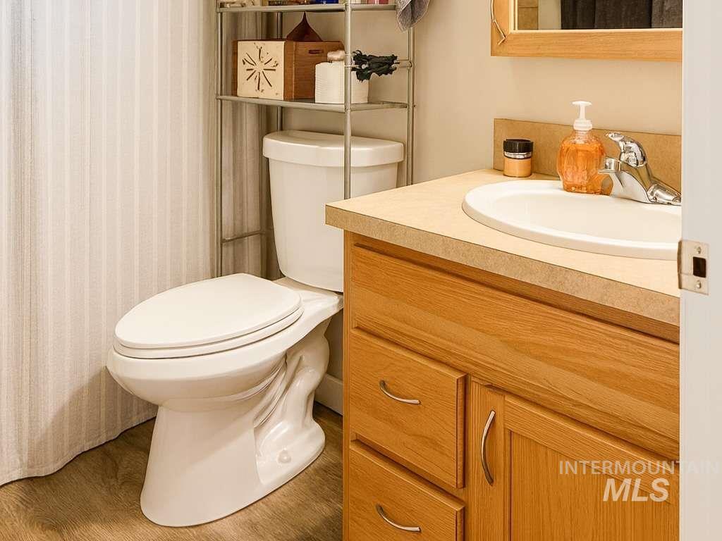 Bathroom with vanity and wood finished floors