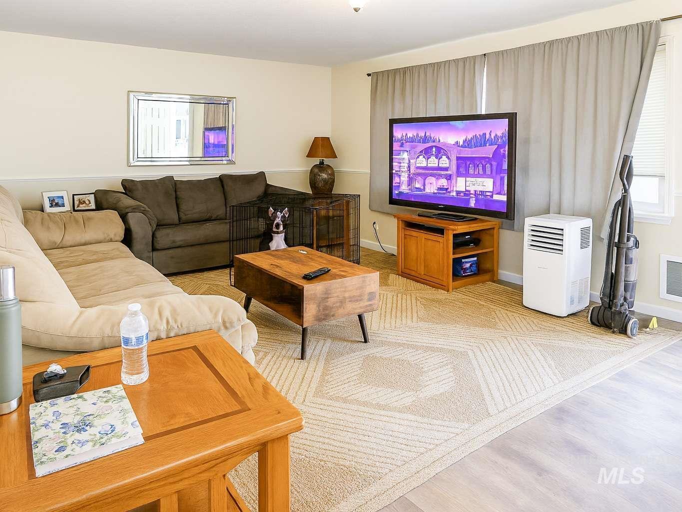 Living area with baseboards and light wood-type flooring