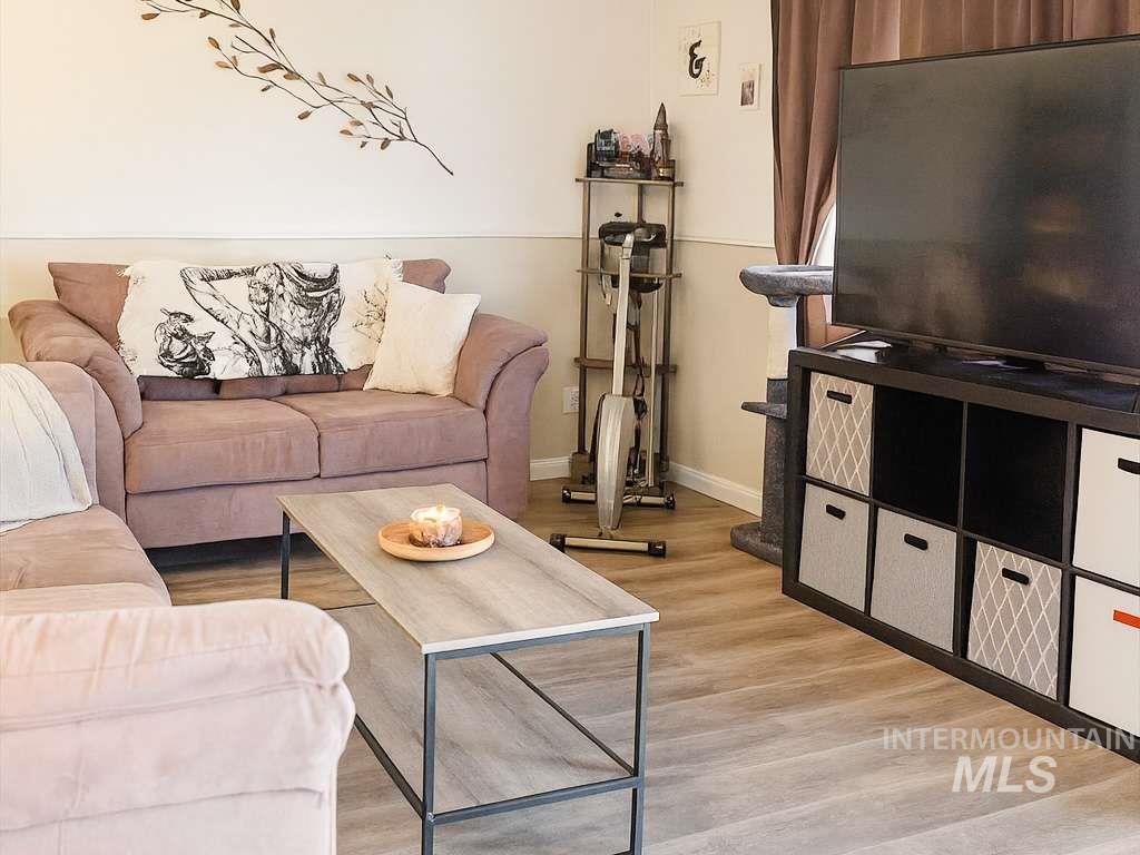 Living room with light wood-style floors and baseboards