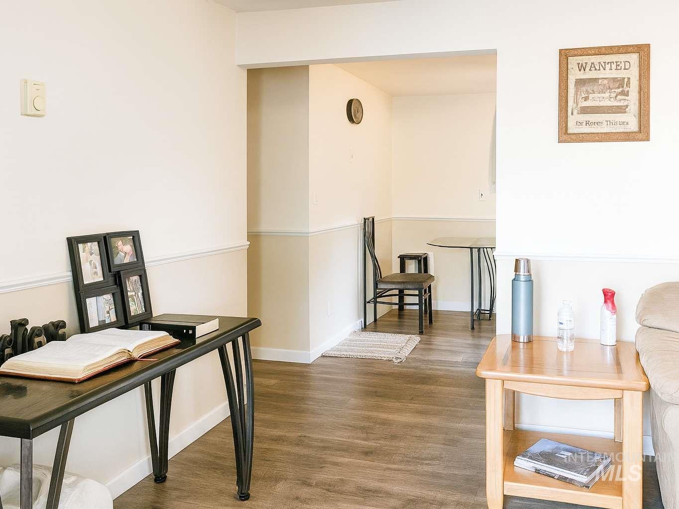Hallway featuring wood finished floors and baseboards