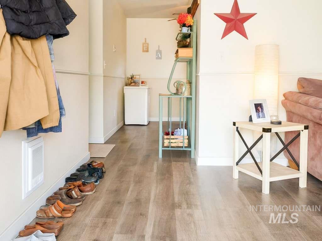 Living area with wood finished floors and baseboards