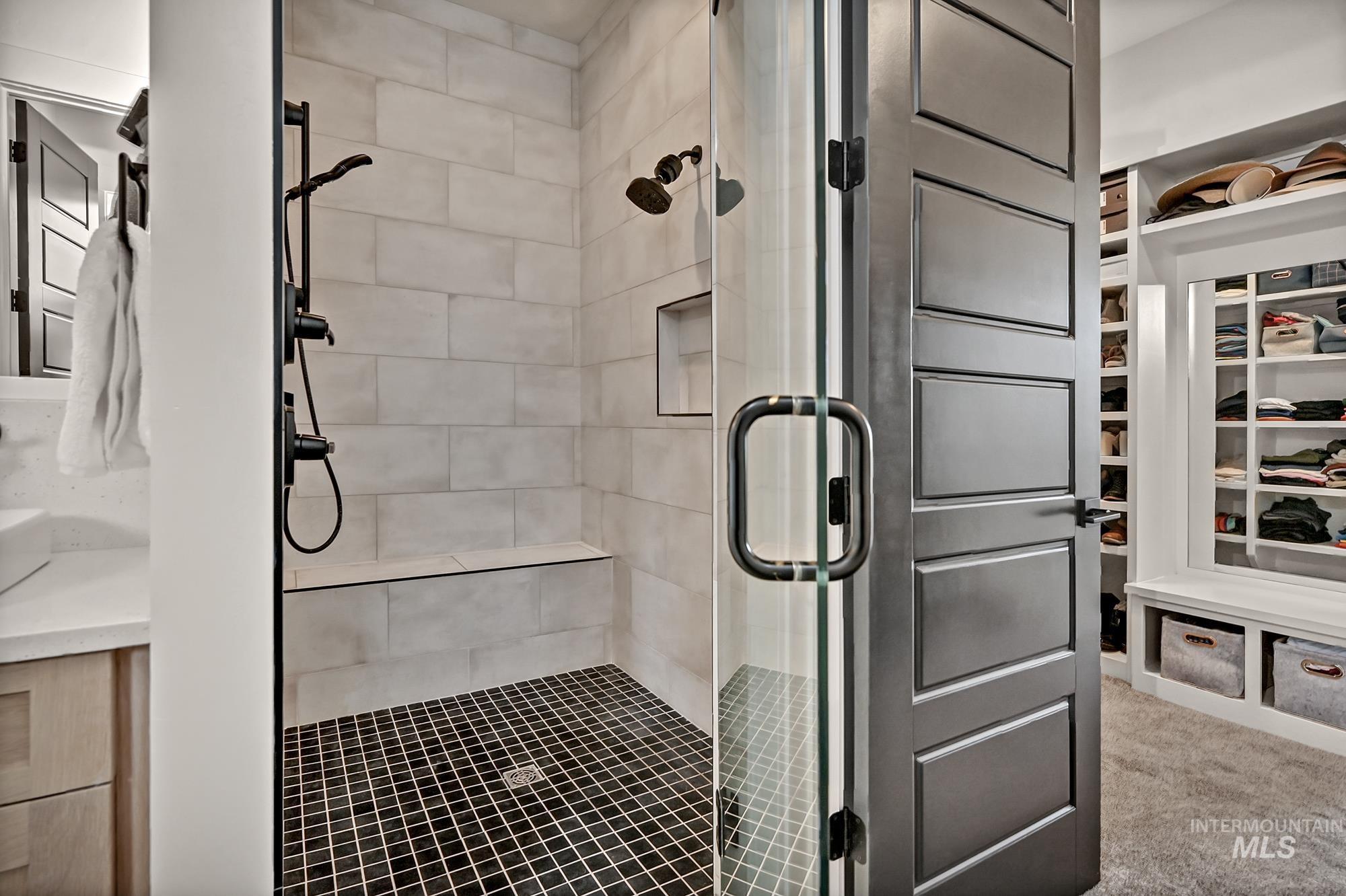 Bathroom featuring a stall shower and a closet