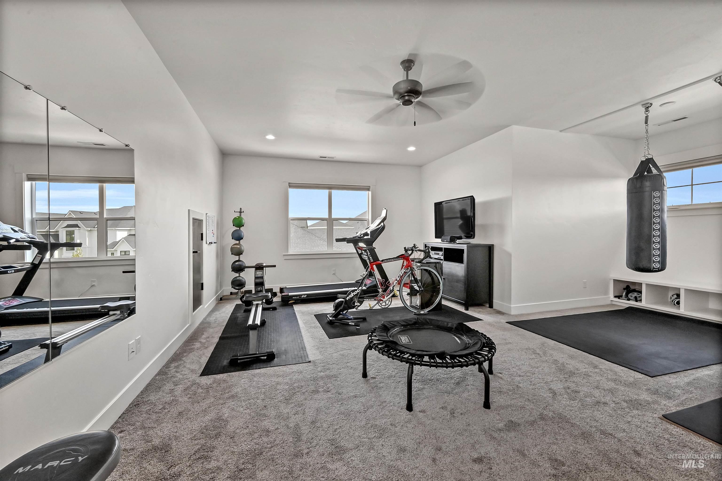 Exercise area with carpet floors, recessed lighting, and a ceiling fan