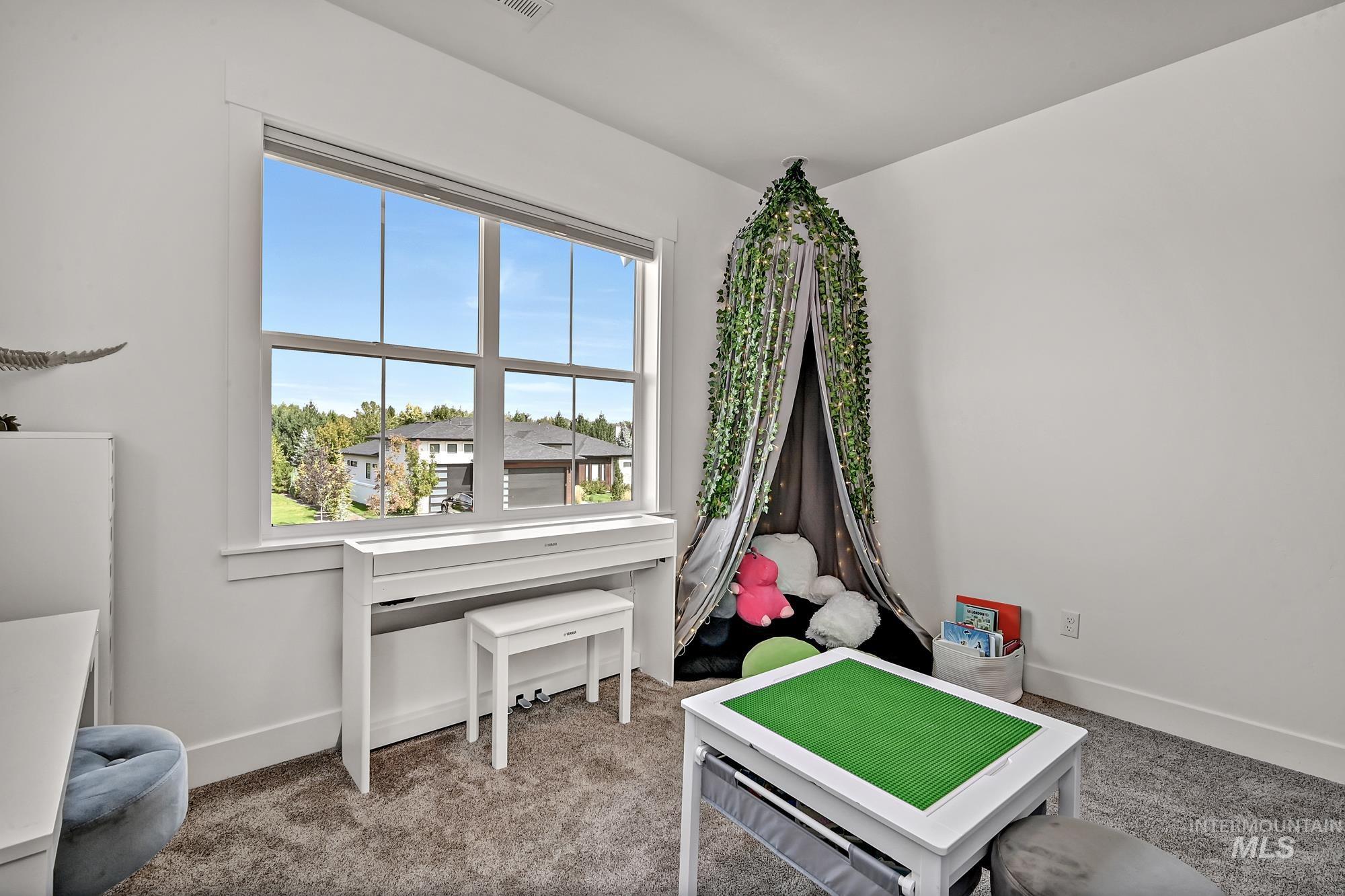 Recreation room featuring carpet and baseboards