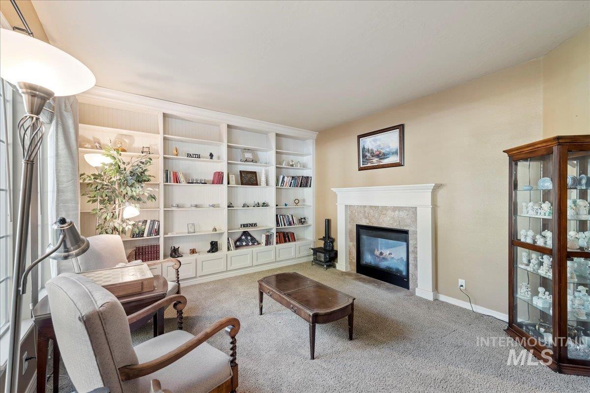 Living room with a premium fireplace and carpet flooring
