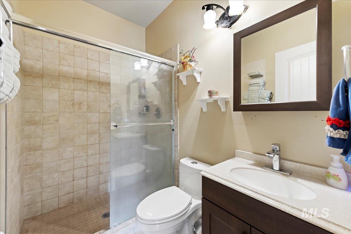 Full bathroom featuring a stall shower and vanity