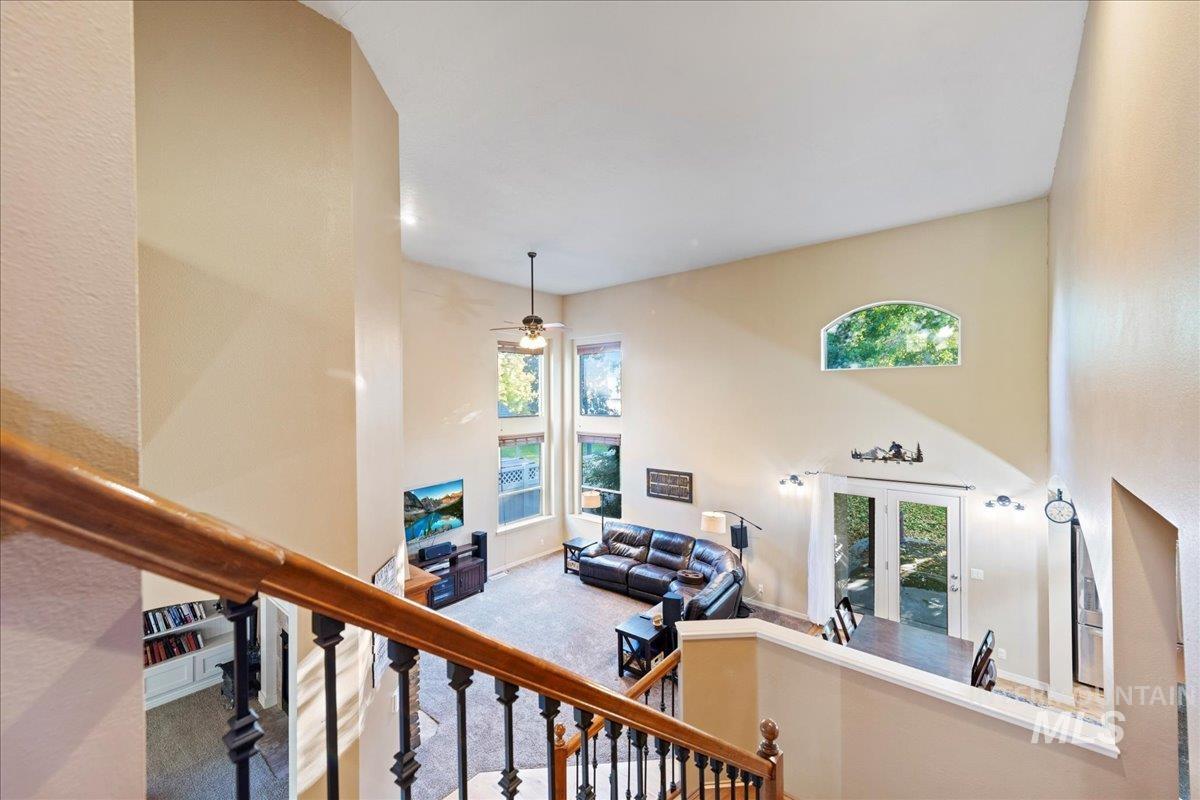 Staircase with carpet, french doors, a high ceiling, plenty of natural light, and ceiling fan