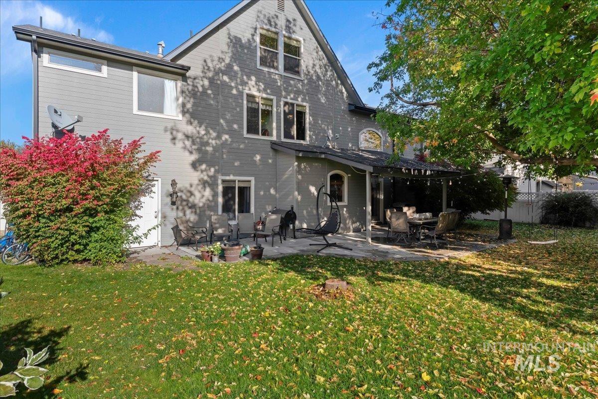 Rear view of house with a patio and a yard