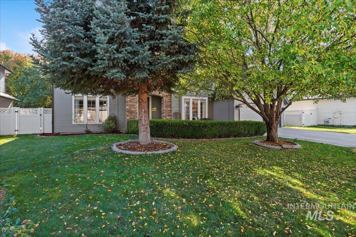 Obstructed view of property with a gate, driveway, and an attached garage
