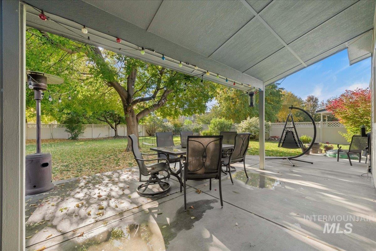 Fenced backyard featuring a patio and outdoor dining space
