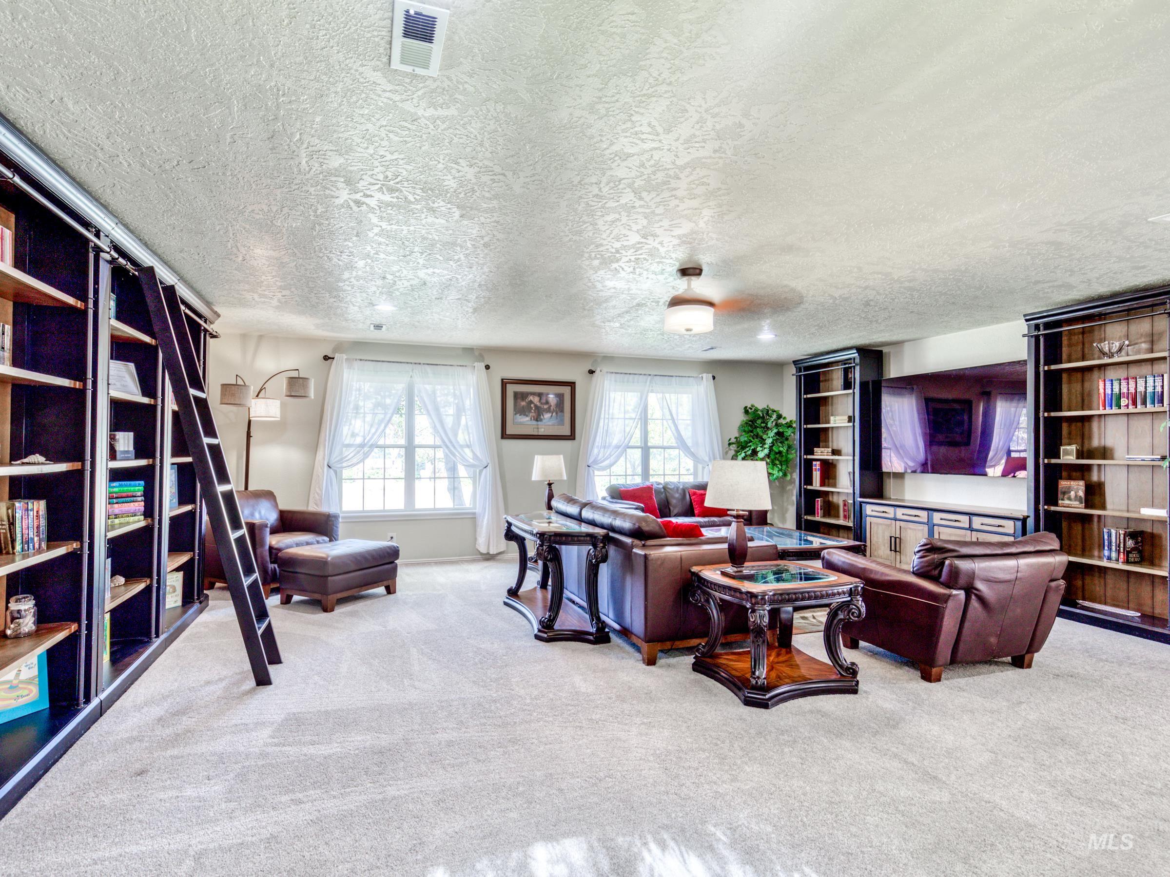 Living room featuring carpet floors and a textured ceiling