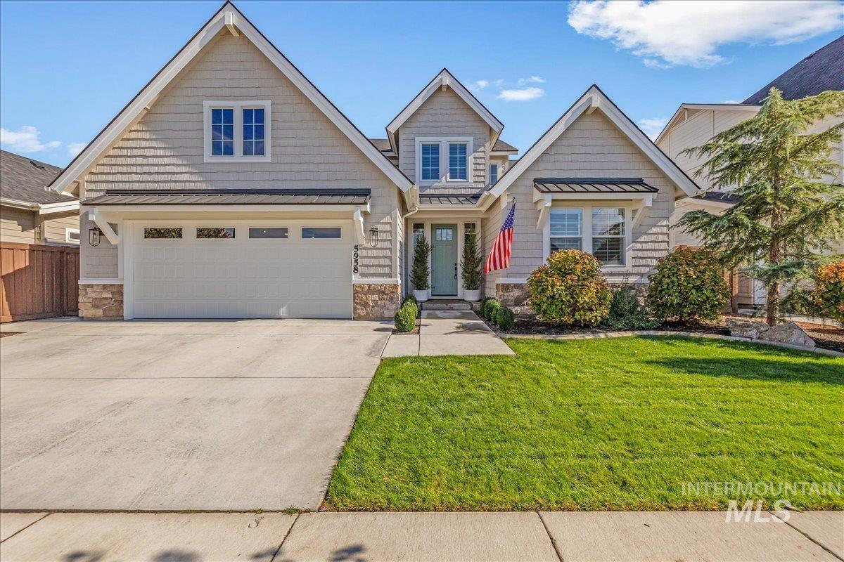 Craftsman-style house with a standing seam roof, a metal roof, concrete driveway, and a garage