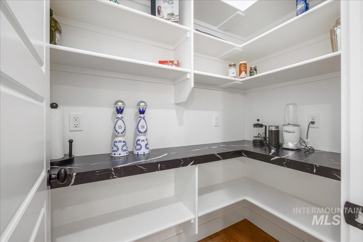 Kitchen featuring dark countertops and wood finished floors