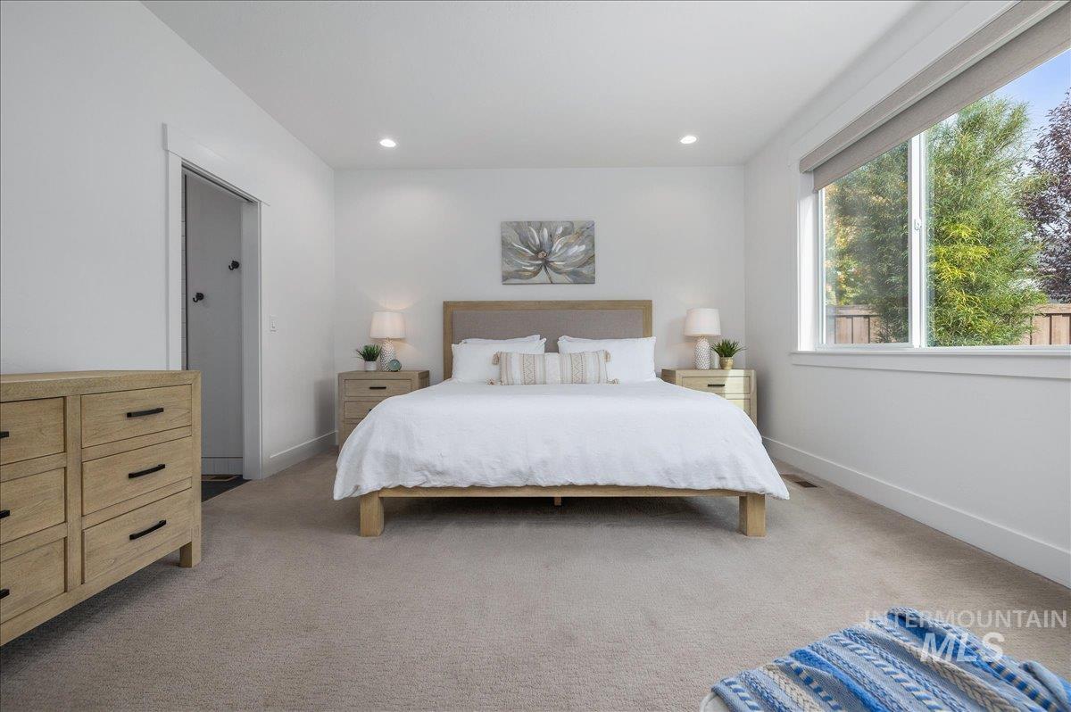 Bedroom featuring light carpet and recessed lighting